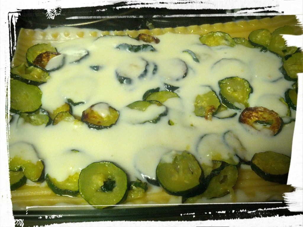 Smothering the oven-roasted zucchini with the parmesan white sauce. Don't worry about spreading the sauce to the corners -- with many more saucy layers to come, it'll work itself out! 