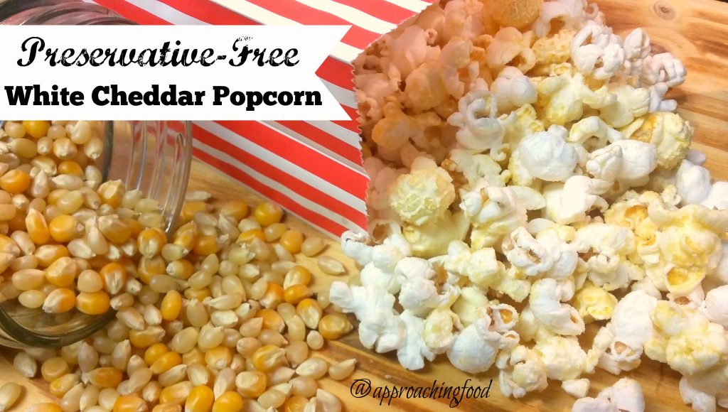 Preservative-free white cheddar popcorn spilling out of a bag, ready to eat!