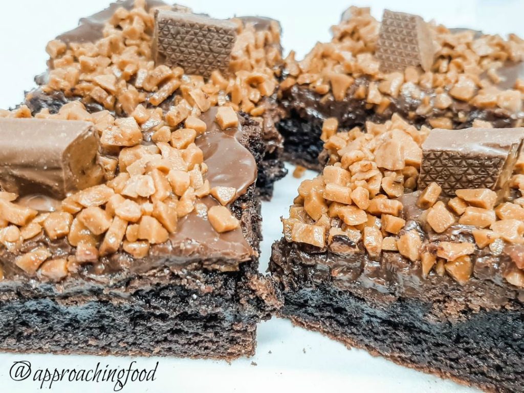 Fudge brownies topped with fudge icing and toffee chocolate bar -- must. eat. now!