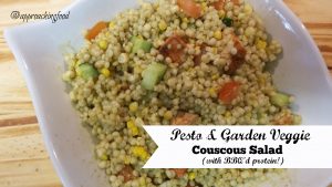 Bowl of pearl couscous and pesto salad with fresh veggies and bbq'd protein