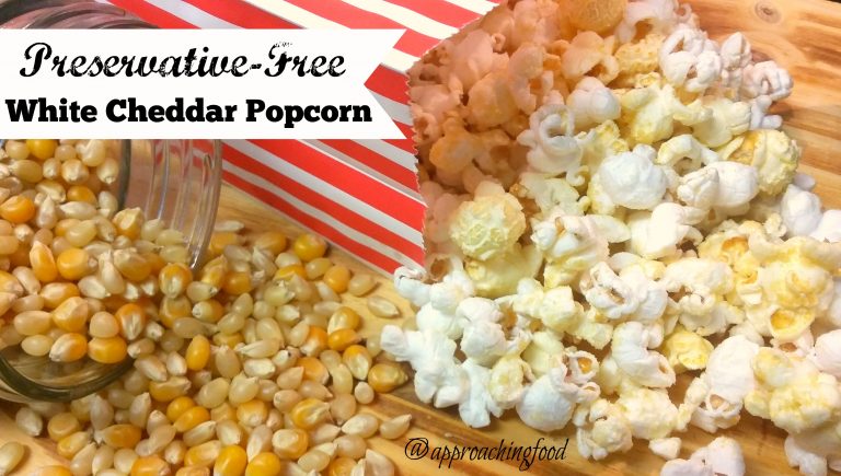 Preservative-free white cheddar popcorn spilling out of bag.